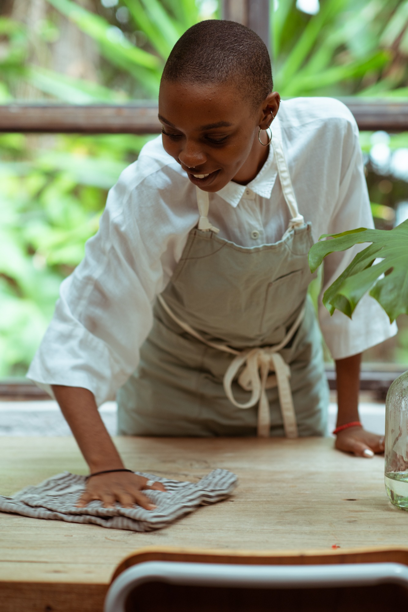 woman cleaning a table