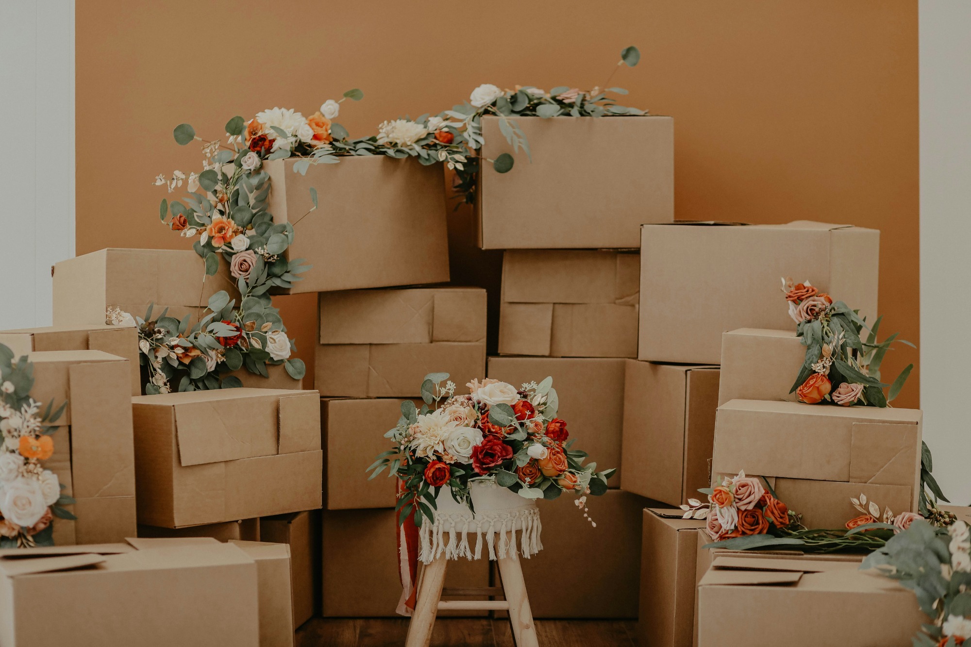 A neatly organized living room filled with labeled moving boxes, ready for unpacking, in a bright, clean home.