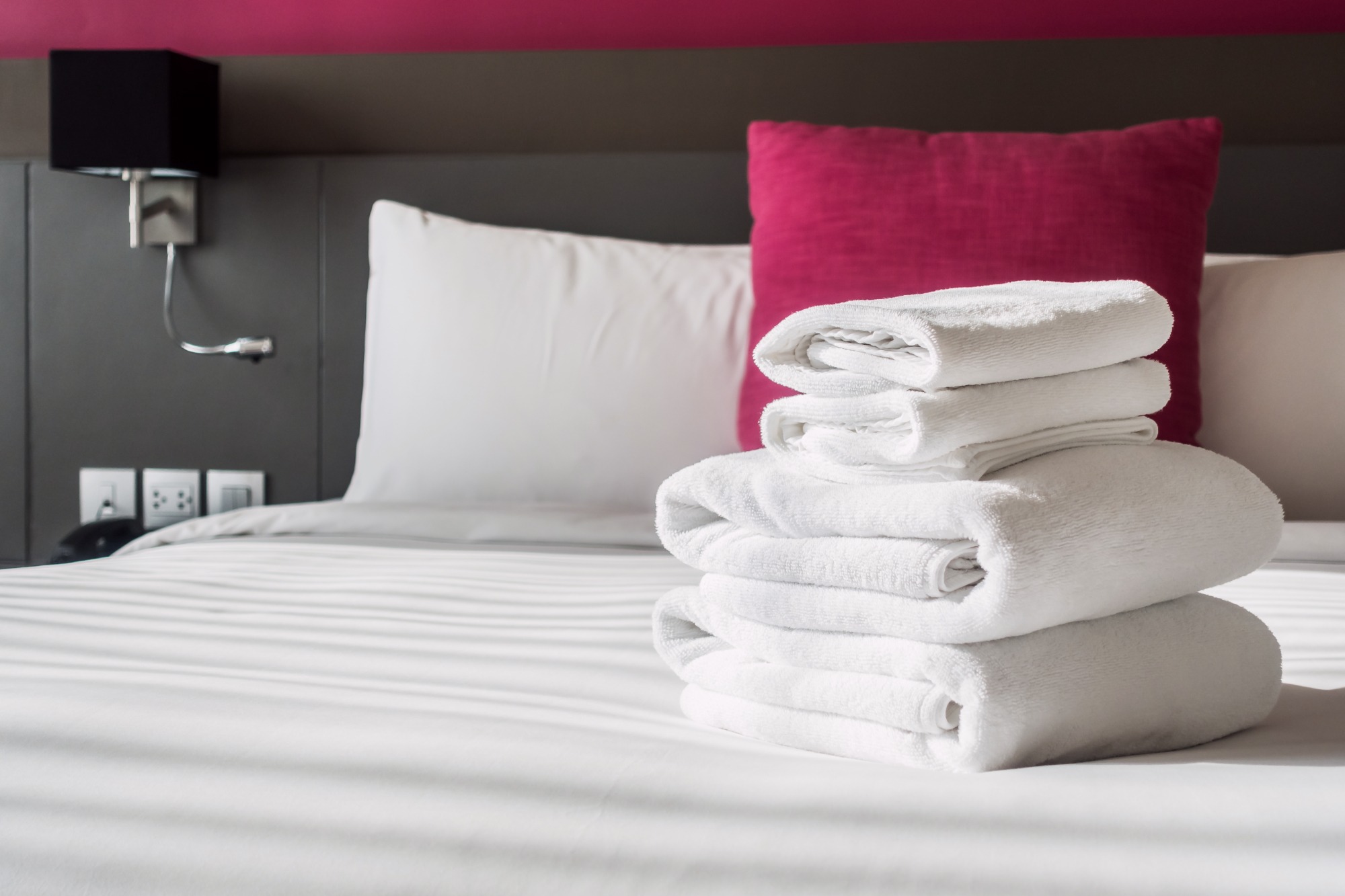 Pristine guest-ready bed with fresh towels